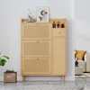 A wooden shoe cabinet with rattan detailing is shown in a room setting. Podgląd zdjęcia produktu