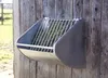 A metal hay feeder is mounted on a wooden wall. Anteprima dell’immagine prodotto