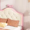 Close-up of a pink and cream upholstered headboard with LED lighting and decorative pillows. Anteprima dell’immagine prodotto