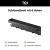 A black key holder with 6 hooks and a small shelf, presented against a white background with marketing text and icons. Produktbild-Vorschau