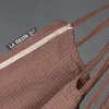 A close-up view of a brown hammock with a white stripe and a 'LA SIESTA' logo tag. Produktbild-Vorschau