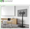 A modern office or meeting room setting with a whiteboard, a table with a laptop and chairs, and a TV stand with a TV. Produktbild-Vorschau