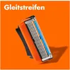 A close-up shot of a razor head with multiple blades, set against an orange background. Produktbild-Vorschau