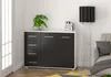 A modern living room scene featuring a black and white sideboard, a floor lamp, and a sofa. Voir les images du produit