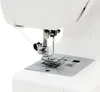 Close-up of the needle and presser foot of a white sewing machine. Produktbild-Vorschau