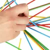 A hand is holding a bundle of colorful sticks, likely from a game. Náhled obrázku produktu