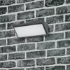 A modern LED outdoor wall light mounted on a brick wall. Produktbild-Vorschau