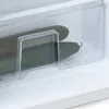 Close-up of two cucumbers in a refrigerator crisper drawer. Voir les images du produit