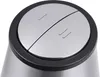 A close-up view of the top of a stainless steel appliance with a black rim and two silver buttons. Produktbild-Vorschau