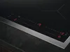 A close-up view of a modern induction cooktop with red digital displays. Produktbild-Vorschau