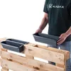 A person is holding a planter box over a wooden pallet. Náhľad obrázku produktu