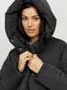 A woman wearing a black puffer coat. Produktbild-Vorschau