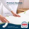 Hands touching a white incontinence pad on a bed. Produktbild-Vorschau