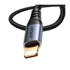 A close-up shot of the connector end of a black braided audio cable. Anteprima dell’immagine prodotto