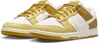 A pair of Nike Dunk Low Retro sneakers in a white and gold colorway. Anteprima dell’immagine prodotto