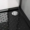 A close-up view of a black shower tray with a silver drain cover. Produktbild-Vorschau