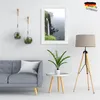 A living room scene with a sofa, framed picture, plants, and a floor lamp. Produktbild-Vorschau