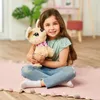 A young girl is sitting on a pink rug, holding a stuffed dog. Anteprima dell’immagine prodotto