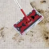A red swivel sweeper cleaning a tiled floor with dirt. Produktbild-Vorschau