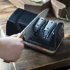 A hand is sharpening a knife on an electric knife sharpener. Podgląd zdjęcia produktu