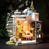 A detailed miniature dollhouse with a spiral staircase, balcony, and interior rooms filled with furniture and decor. Anteprima dell’immagine prodotto