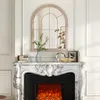 A decorative arched mirror above a marble fireplace with an electric fire. Náhľad obrázku produktu