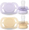 Two pairs of baby pacifiers, one purple and one beige, displayed against a white background. Anteprima dell’immagine prodotto