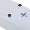 A close-up view of the underside of a white electronic device, showing two circular rubber feet and an 'X' shaped plastic protrusion. Produktbild-Vorschau