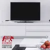 A modern living room setup with a TV on a white media console, and a white coffee table in the foreground. Náhled obrázku produktu