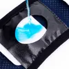 A close-up of a dog diaper insert with blue liquid being poured onto it to demonstrate absorbency. Produktbild-Vorschau