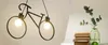A collage showing a bicycle-shaped pendant light on the left and a vase with eucalyptus branches and books on the right. Podgląd zdjęcia produktu