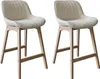 Two beige bar stools with wooden legs are shown against a white background. Voir les images du produit