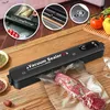 A vacuum sealer is shown sealing a piece of meat on a wooden table. Produktbild-Vorschau