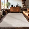 A living room with a wooden cabinet, plants, and a sofa, featuring a rug. Produktbild-Vorschau