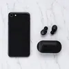 A black smartphone and black wireless earbuds with their charging case are laid out on a marble-like surface. Anteprima dell’immagine prodotto