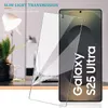 A screen protector is shown leaning against a smartphone on a desk with a lamp and plant in the background. Produktbild-Vorschau