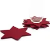 A stack of red star-shaped coasters with a glass on top, and one coaster in the foreground. Produktbild-Vorschau