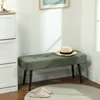 A green bench with a hat on it, next to a white cabinet, with slippers on a rug in front. Produktbild-Vorschau