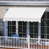 A white awning is installed above a set of glass doors on a house, extending over a balcony with a white railing. Náhľad obrázku produktu