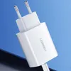 A close-up shot of a white Ugreen USB charger against a blue and dark gray background. Náhled obrázku produktu