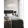 A bedroom scene with a bed, headboard, lamp, and a pendant light. Podgląd zdjęcia produktu