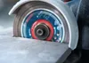 Close-up of a cutting disc on an angle grinder cutting into a stone surface. Produktbild-Vorschau
