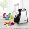 A Zilan electric grater with multiple attachments and chopped vegetables on a wooden surface, with a blurred background of a plant and bottles. Anteprima dell’immagine prodotto