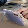 A hand is adjusting a Samsung phone in a transparent case with a kickstand, placed on a desk. Náhľad obrázku produktu