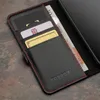 A close-up view of a black leather phone case with red stitching, showing card slots and a banknote. Anteprima dell’immagine prodotto