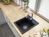 A kitchen sink with a silver chrome faucet on a wooden countertop. Anteprima dell’immagine prodotto