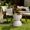 An outdoor patio scene with a chair, sofa, and a small table with cookies and flowers. Podgląd zdjęcia produktu