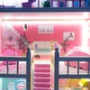 Interior view of a multi-story dollhouse with furniture and LED lighting. Voir les images du produit