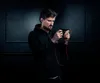 A man is playing a mobile game with earphones on. Produktbild-Vorschau