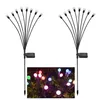 Two solar-powered garden lights with multiple LED bulbs on flexible stems, shown against a white background. A smaller inset image shows the lights illuminated with colorful LEDs in a garden setting. Produktbild-Vorschau